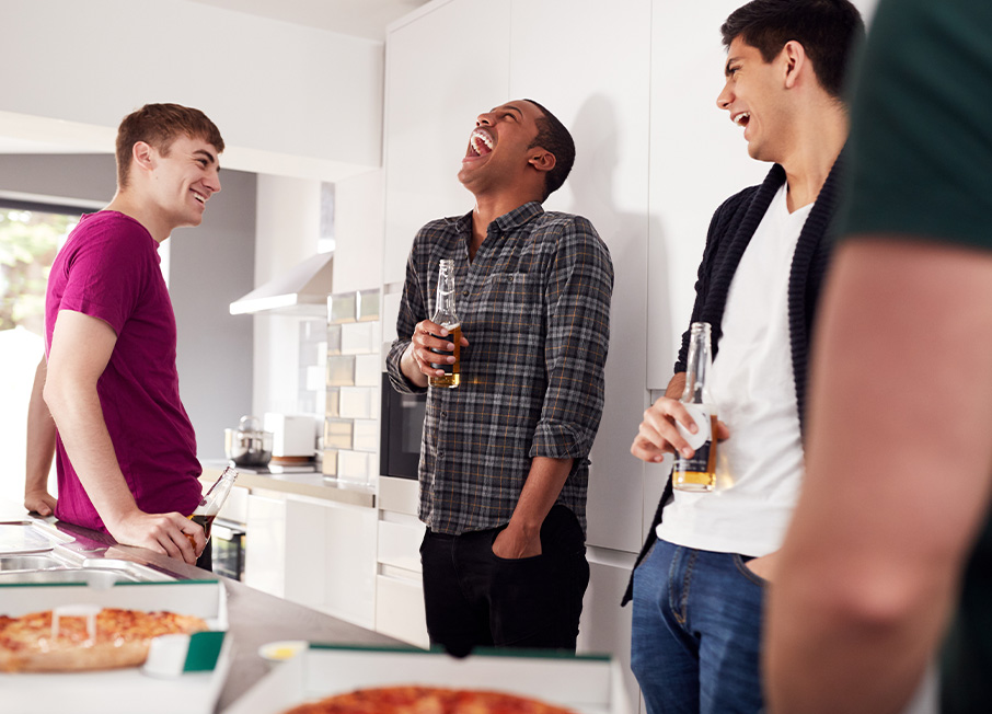 Men talking in kitchen at a party